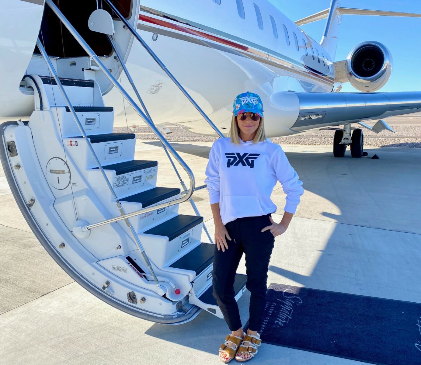 Renee Parsons standing next to a jet