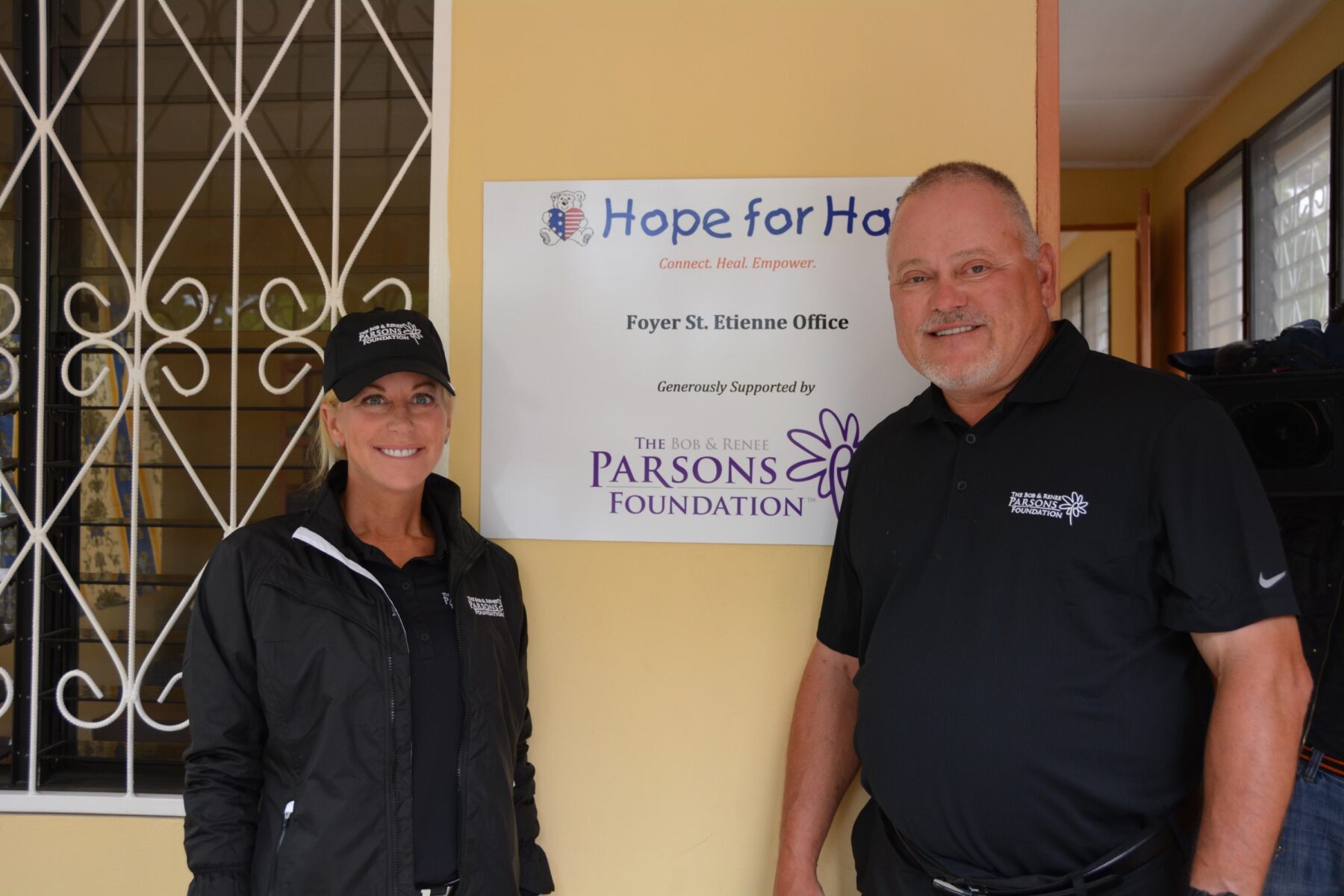 Bob and Renee Parsons, Hope for Haiti sign