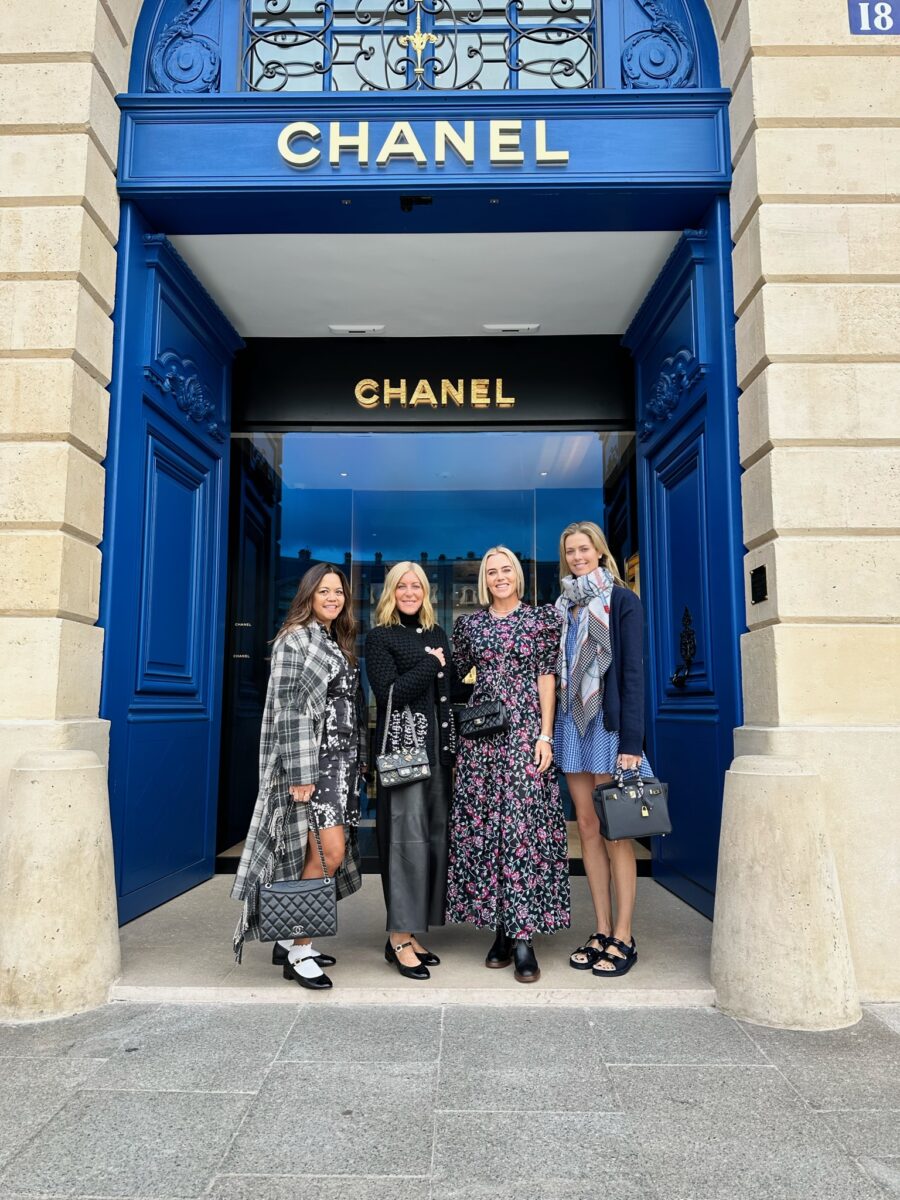 4 women pose outside of a Chanel store in Paris 