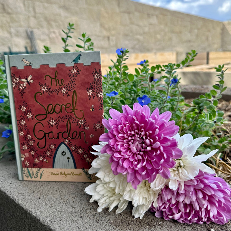 The book The Secret Garden next to flowers